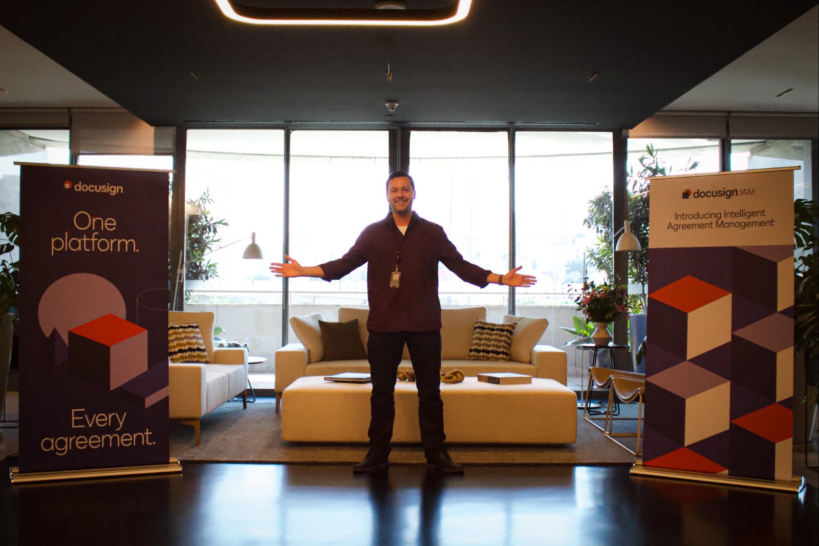 Nicolas at a Docusign event between two Docusign banners